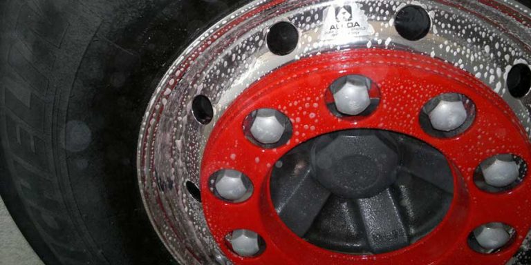 A big-rig wheel foamed up and ready for detailing