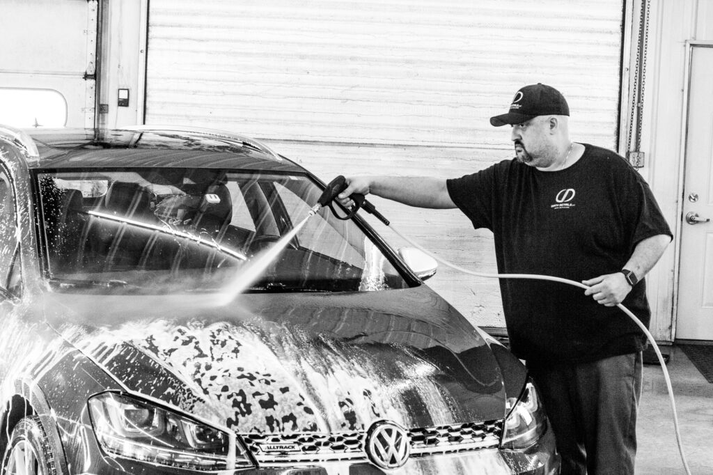 Fresh water rinse after a car foam bath.