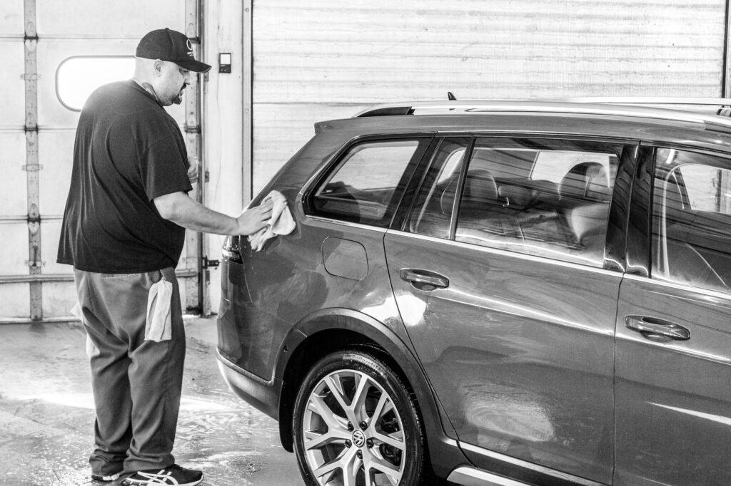 Hand drying outside of car after a rinse.