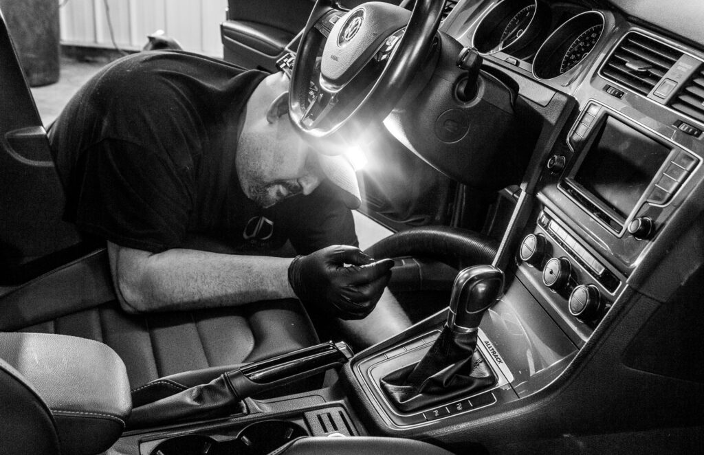 Photo showing staff cleaning interior with a head light,
