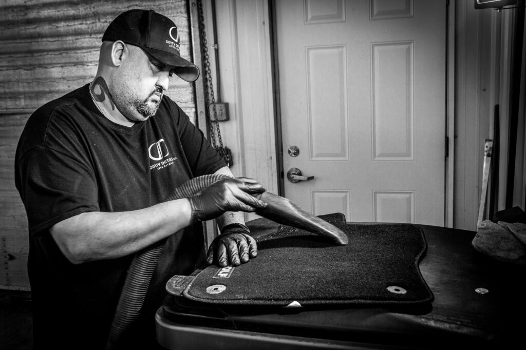 Andy vacuuming floor mats