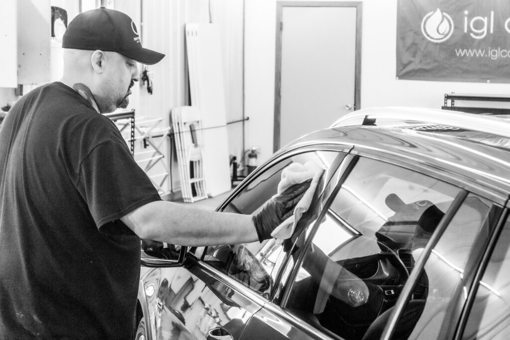 After a ceramic wax is applied this red VW car is hand-buffed to a mirror shine on both painted surfaces and glass.