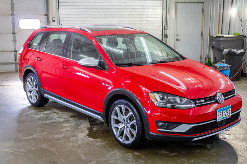 Red VW Alltrack having had the Value Package with ceramic spray.,