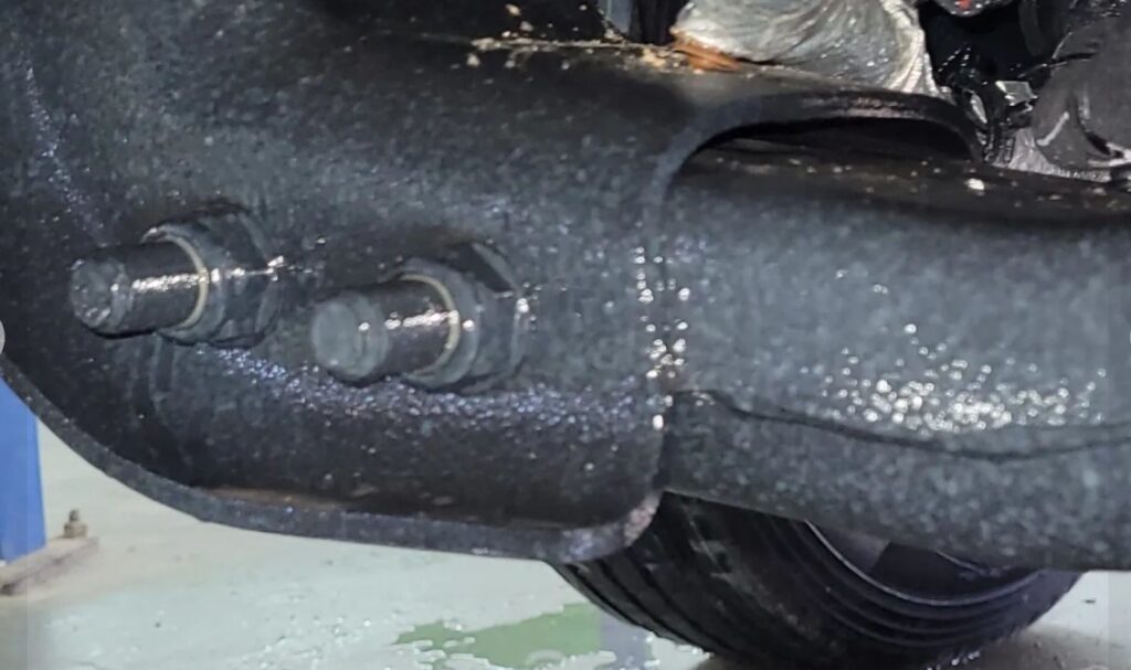 Commercial application of WoolWax undercoating on a new vehicle.